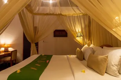 a bedroom with a bed with a canopy at Villa Elegant by Exotiq in Seminyak