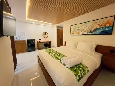 a hotel room with a large bed with towels on it at Seminyak Apartment 37 in Seminyak