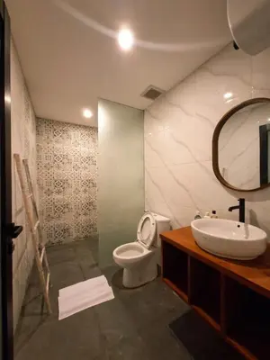a bathroom with a toilet and a sink and a mirror at Seminyak Apartment 37 in Seminyak