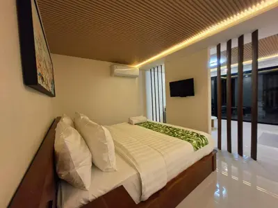 a bedroom with a bed and a television in it at Seminyak Apartment 37 in Seminyak