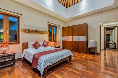 a bedroom with a large bed in a room at Panatai Villa in Sanur