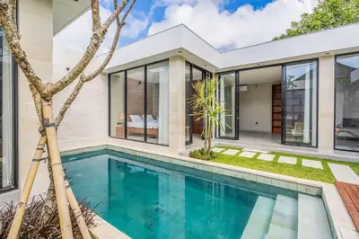 a house with a swimming pool in front of it at Jimbaran Villa in Jimbaran