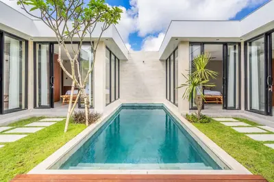 a swimming pool in the backyard of a house at Jimbaran Villa in Jimbaran