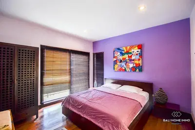 a bedroom with a purple wall with a bed at Villa Ayu in Kerobokan