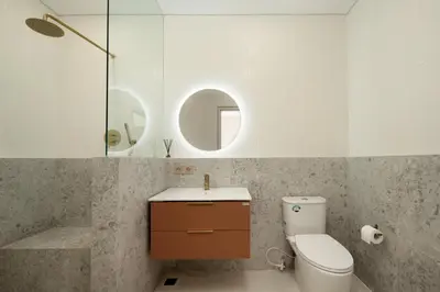 a bathroom with a toilet and a sink and a mirror at Alegria De La Casa Seminyak in Seminyak
