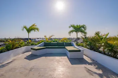 a couch sitting on top of a balcony at Luxury 4BR Villa Private Pool & Sea Horizon in Kerobokan