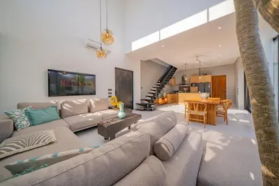 a living room with a couch and a table at Luxury 4BR Villa Private Pool & Sea Horizon in Kerobokan