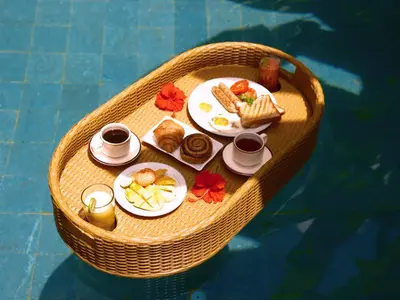 a tray of breakfast food on a table in a boat at De Awan Villa in Kerobokan
