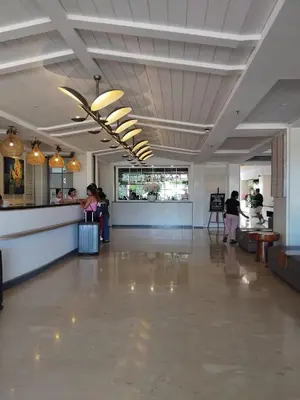 a lobby of a restaurant with people waiting at a counter at Sweet Condo in Seminyak
