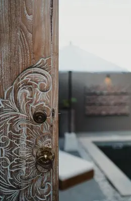 a wooden door with a design on it at Dikubu Belong in Seminyak
