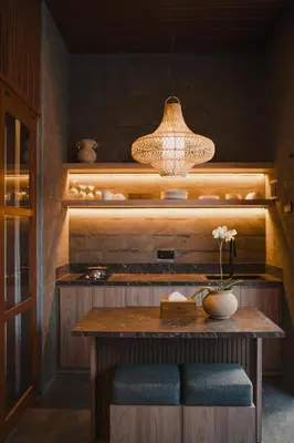 a dining room with a table and a light fixture at Dikubu Belong in Seminyak