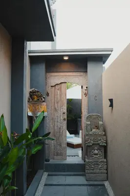 an entrance to a house with a wooden door at Dikubu Belong in Seminyak