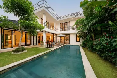 a swimming pool in the backyard of a house at Spacious 5BR Modern Simplicity, Near Canggu's Best in Canggu