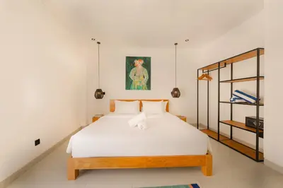 a bedroom with a white bed in a room at Spacious 5BR Modern Simplicity, Near Canggu's Best in Canggu