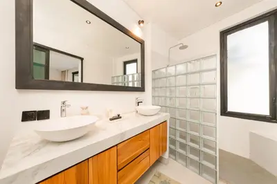 a bathroom with two sinks and a large mirror at Spacious 5BR Modern Simplicity, Near Canggu's Best in Canggu