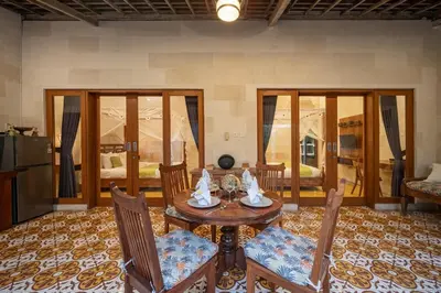 a dining room with a table and chairs in a room at Villa Gema Asri - Boho Chic Oasis in Central Petitenget in Seminyak