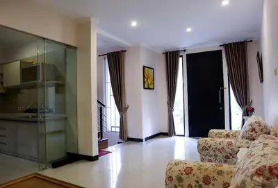 a living room with two couches and a kitchen at Sunrise Aventus Villa Nusa Dua in Nusa Dua