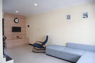 a living room with a couch and a chair at Sunrise Aventus Villa Nusa Dua in Nusa Dua