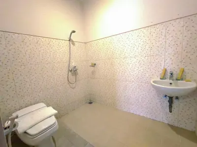 a bathroom with a toilet and a sink at Sunrise Aventus Villa Nusa Dua in Nusa Dua