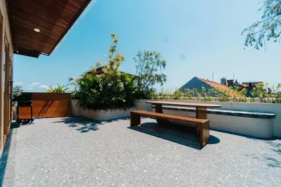 a wooden bench sitting on top of a patio at Villa Bens Luxury - 3BR Villa in Kerobokan in Kerobokan