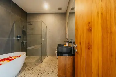 a bathroom with a tub and a shower and a sink at Villa Bens Luxury - 3BR Villa in Kerobokan in Kerobokan
