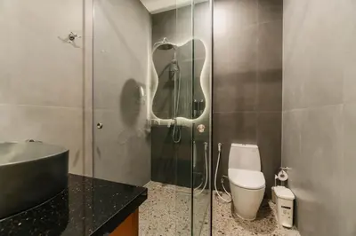 a bathroom with a shower and a toilet and a sink at Villa Bens Luxury - 3BR Villa in Kerobokan in Kerobokan