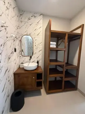 a bathroom with a sink and a mirror at Flamboyant Guesthouse in Seminyak
