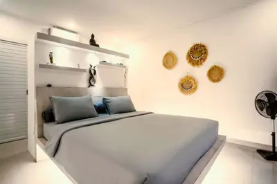 a bedroom with a large white bed in a room at Davion 6 BR Private Pool Villa in Seminyak