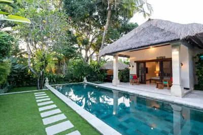 a villa with a swimming pool and a house at 4-Bedroom Villa - Large swimming pool - Ideal place for friends and families in Seminyak