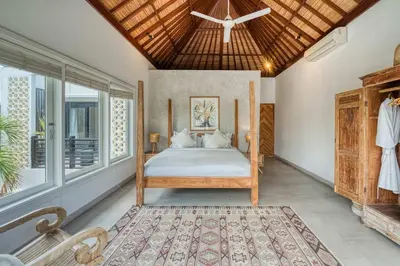 a bedroom with a bed and a large window at Villa Meya 3 Bedroom Villa in Central Seminyak in Seminyak
