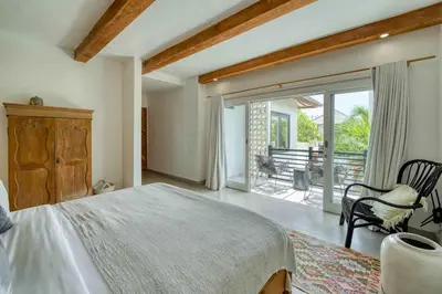 a bedroom with a bed and a sliding glass door at Villa Meya 3 Bedroom Villa in Central Seminyak in Seminyak