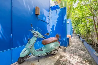a scooter parked next to a blue wall at Villa Kanari,5 bed & pool in Seminyak