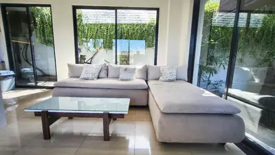 a living room with a couch and a coffee table at Villa Lans By Baliem Villa in Jimbaran