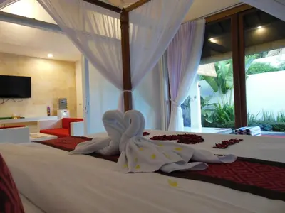 a bedroom with a bed with towels on it at HK Villa Bali in Legian