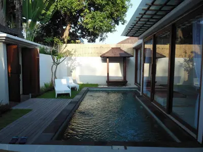 a swimming pool in the backyard of a house at HK Villa Bali in Legian