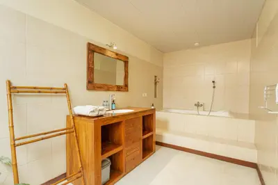 a bathroom with a sink and a tub at Abimanyu Villa 2 Seminyak in Seminyak