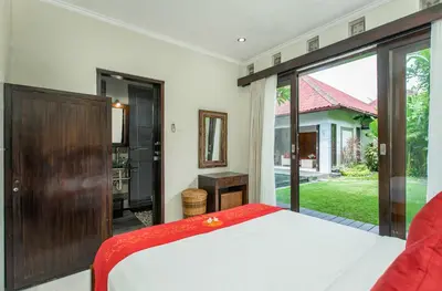 a bedroom with a bed and a large window at Abimanyu Villa 2 Seminyak in Seminyak