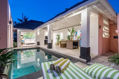 a house with a swimming pool and a house at Ocean Two 1BR Villa Honeymoon Seminyak in Seminyak