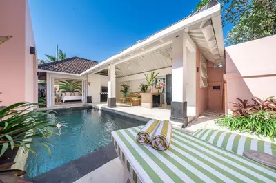 a villa with a swimming pool and a house at Ocean Two 1BR Villa Honeymoon Seminyak in Seminyak