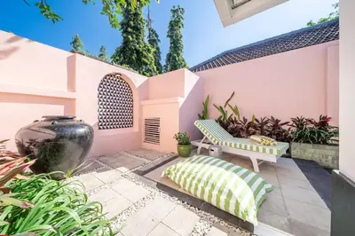 a patio with a bench and a large vase at Ocean Two 1BR Villa Honeymoon Seminyak in Seminyak