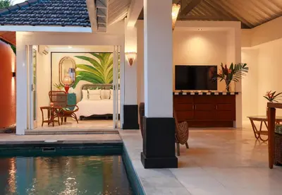 a villa with a swimming pool and a bedroom at Ocean Two 1BR Villa Honeymoon Seminyak in Seminyak