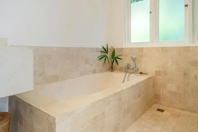 a bath tub with a plant in a bathroom at Ocean Two 3BR Private Pool in Oberoi Seminyak in Seminyak