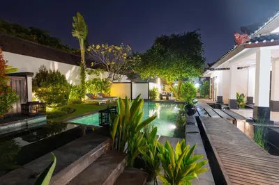 a swimming pool in the backyard of a house at night at Ocean Two 3BR Private Pool in Oberoi Seminyak in Seminyak