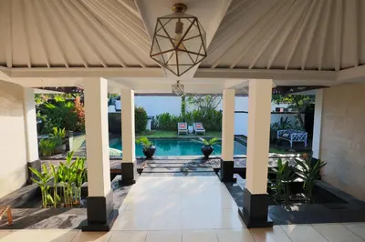 a patio with awning and a swimming pool at Ocean Two 4BR Family Retreat Oberoi in Seminyak
