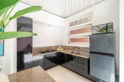 a kitchen with a sink and a refrigerator at Ocean Two 4BR Family Retreat Oberoi in Seminyak