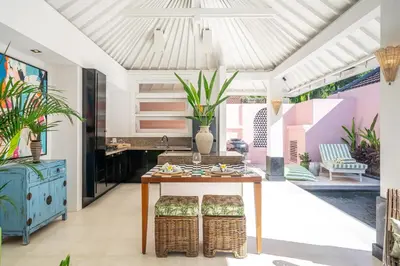 a living room with a table and plants at Ocean Two 4BR Family Retreat Oberoi in Seminyak