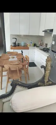 a kitchen with a table and a iguana sitting on a couch at Serene Bali Villa with Private Pool and Antiqued Charm in Balian