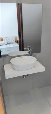 a bathroom with a white sink and a mirror at Serene Bali Villa with Private Pool and Antiqued Charm in Balian