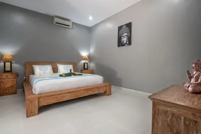 a bedroom with a bed and two night stands at Villa Goodison - Two Bedrooms in Legian