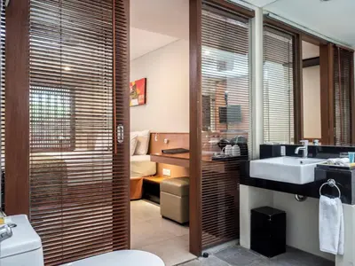 a bathroom with a toilet and a sink at Savvoya Hotel Seminyak in Seminyak